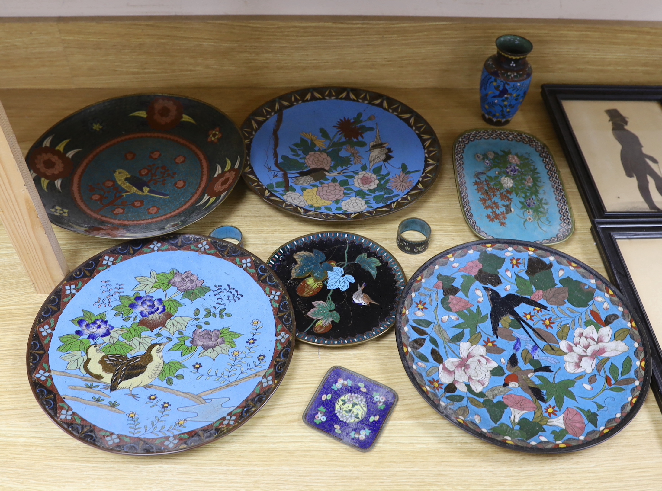 Collection of Japanese cloisonné enamel plates, napkin rings and a vase, each enamelled with birds and flowers, the largest 29cm in diameter